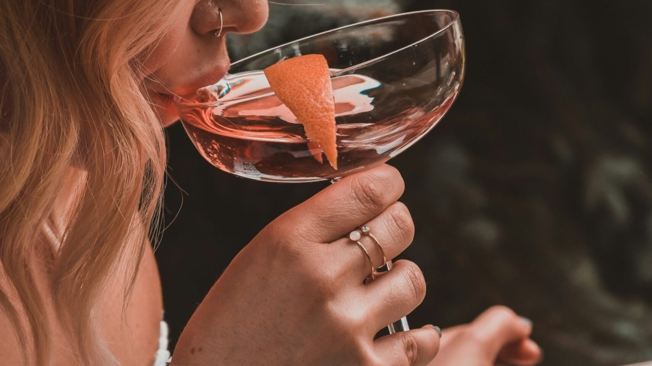 woman holding cocktail glass