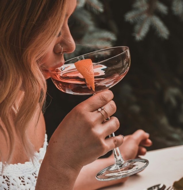 woman holding cocktail glass